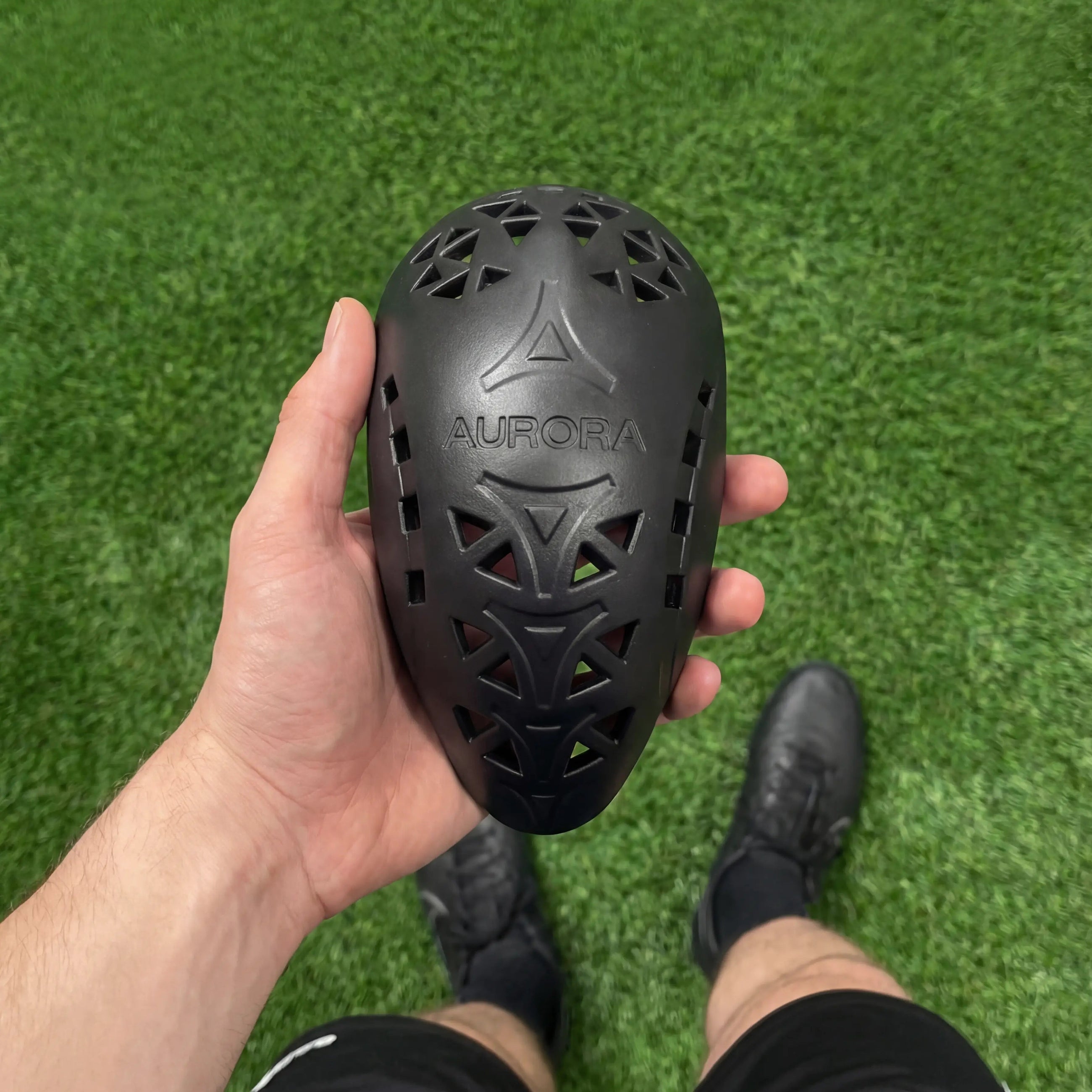 Athlete holding comfortable and flexible Aurora cup on sports field