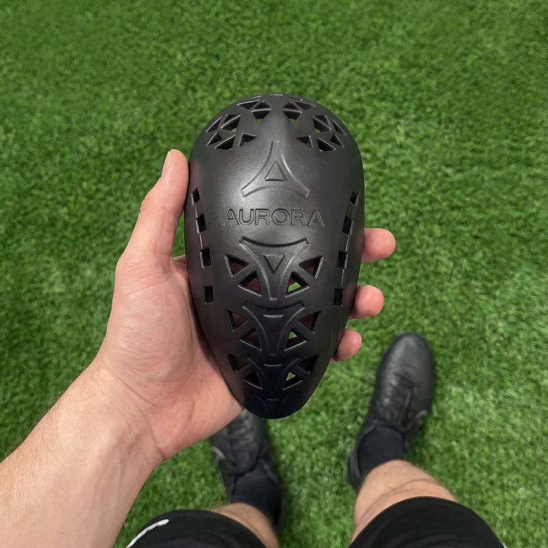 Athlete holding comfortable and flexible Aurora cup on sports field